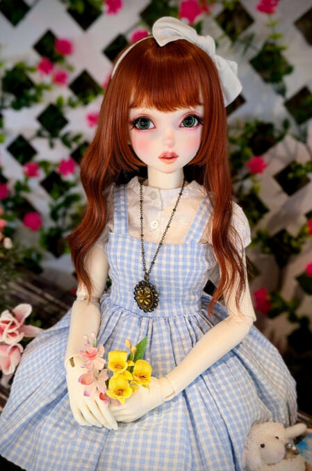 photo of a doll holding flowers